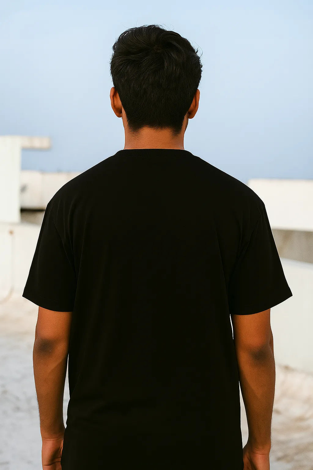 Person wearing a Navy t-shirt with a blurred background