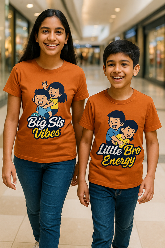 Two children wearing matching orange t-shirts with cartoon characters and text in a shopping mall.