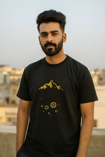 Man wearing a Navy Blue t-shirt with yellow graphics against an urban background