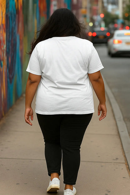 Person wearing a white t-shirt and black pants walking on a sidewalk with a colorful mural in the background.