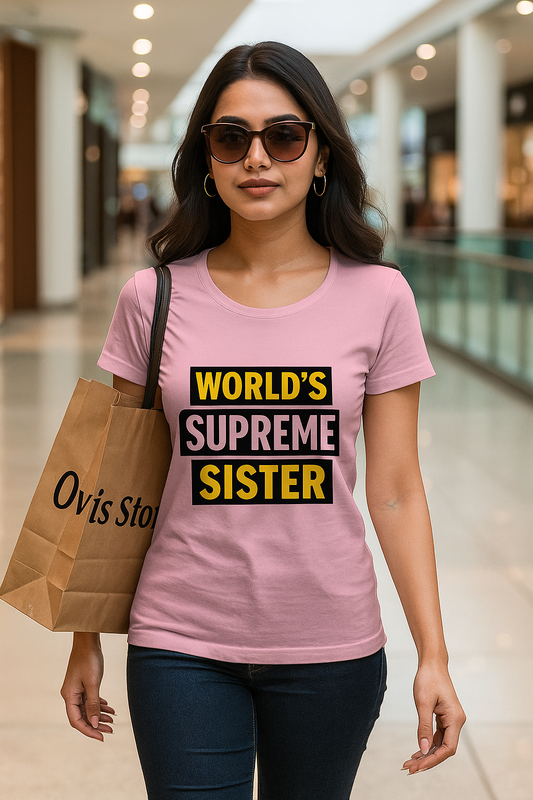 Woman wearing a pink t-shirt with 'World's Supreme Sister' text in a mall.